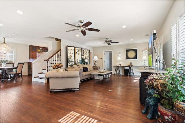 living room with ceiling fan, dark wood-type flooring, and a wealth of natural light