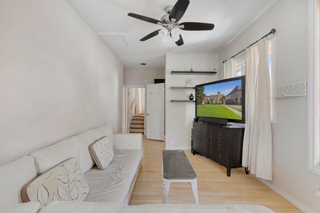 living room featuring ceiling fan and light wood-type flooring