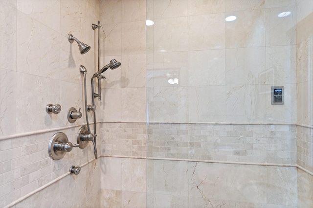 interior details featuring tiled shower