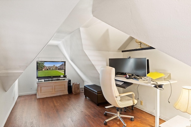 office with dark hardwood / wood-style floors and lofted ceiling