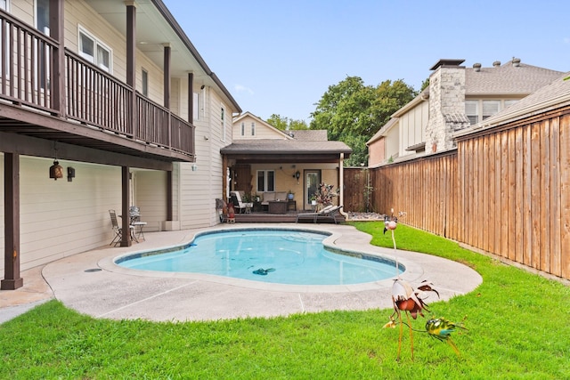 view of swimming pool with outdoor lounge area, a patio area, and a yard