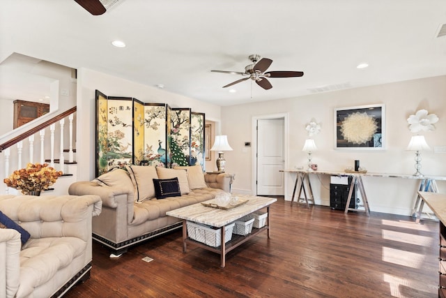 living room featuring dark wood-type flooring and ceiling fan