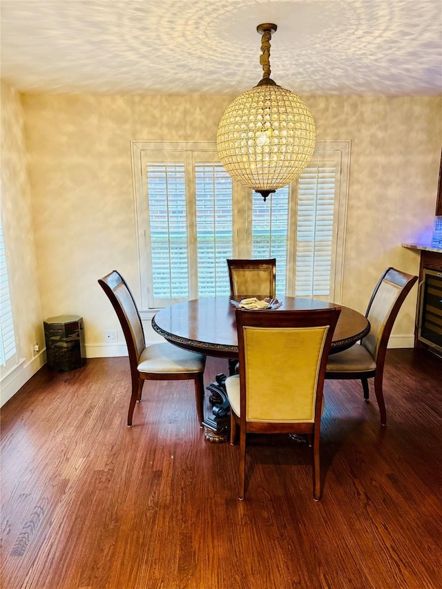 dining area featuring wood-type flooring and an inviting chandelier