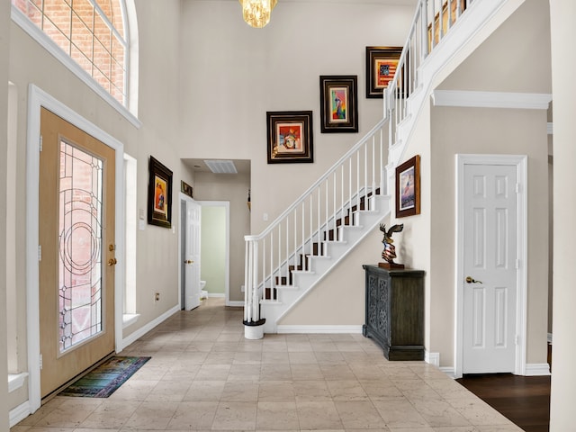 foyer featuring a towering ceiling