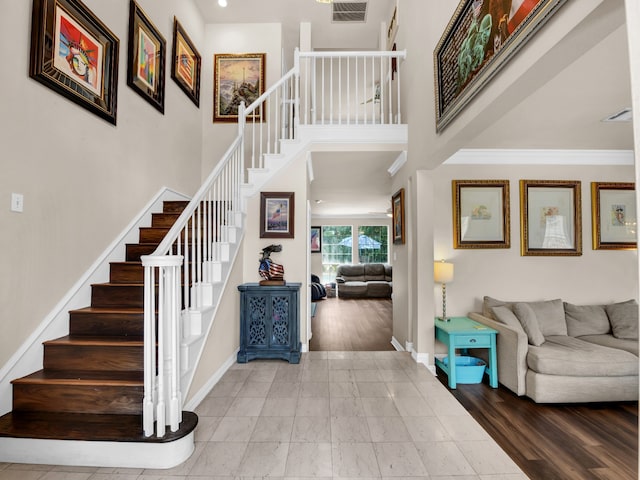 foyer featuring hardwood / wood-style floors and crown molding