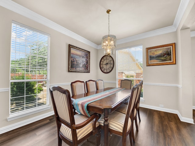 dining room with plenty of natural light, dark hardwood / wood-style floors, ornamental molding, and a chandelier