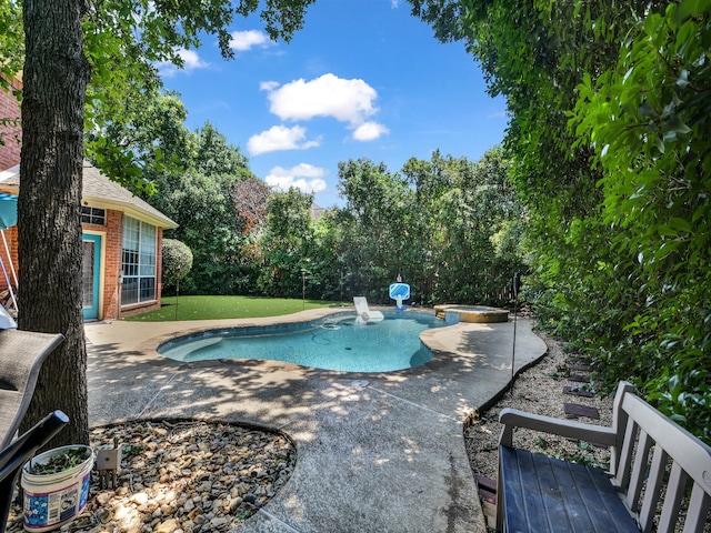 view of swimming pool featuring an in ground hot tub and a patio