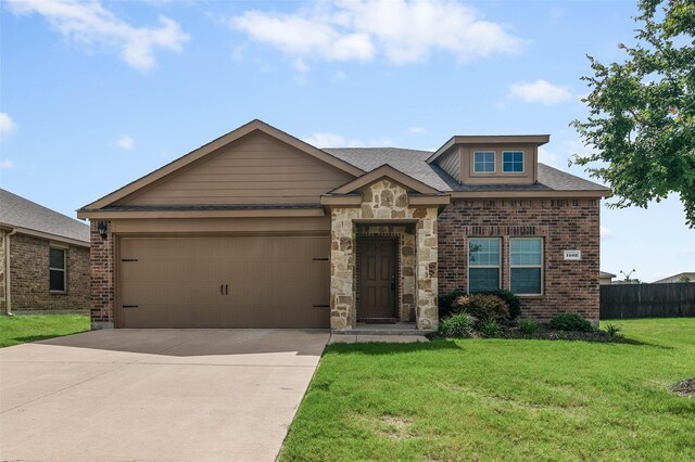 view of front of house featuring a garage and a front lawn