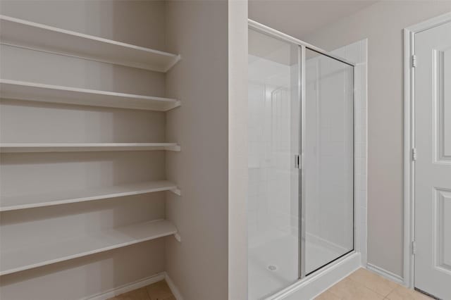 bathroom featuring tile patterned flooring and walk in shower