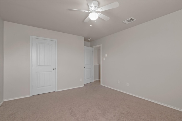 unfurnished bedroom featuring ceiling fan and light carpet