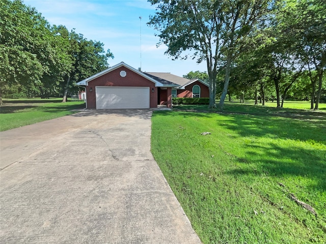 ranch-style house featuring a garage and a front lawn