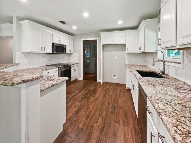 kitchen featuring dark wood-type flooring, sink, light stone countertops, appliances with stainless steel finishes, and white cabinetry