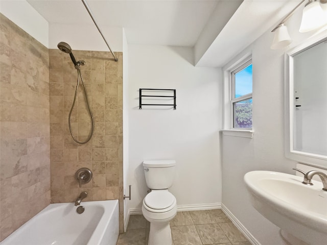 full bathroom with toilet, sink, tiled shower / bath, and tile patterned flooring