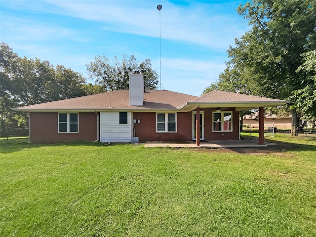 rear view of property featuring a patio area, ceiling fan, and a yard