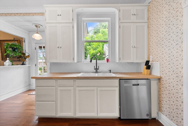 kitchen featuring pendant lighting, dishwasher, backsplash, and sink