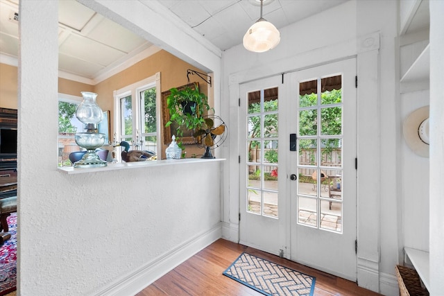 entryway featuring hardwood / wood-style flooring, crown molding, and french doors