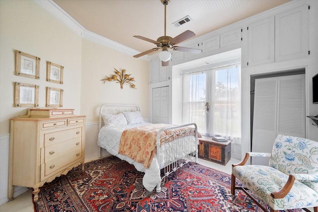 bedroom with ceiling fan, ornamental molding, and french doors