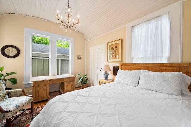 bedroom featuring lofted ceiling, hardwood / wood-style flooring, a notable chandelier, and wood ceiling