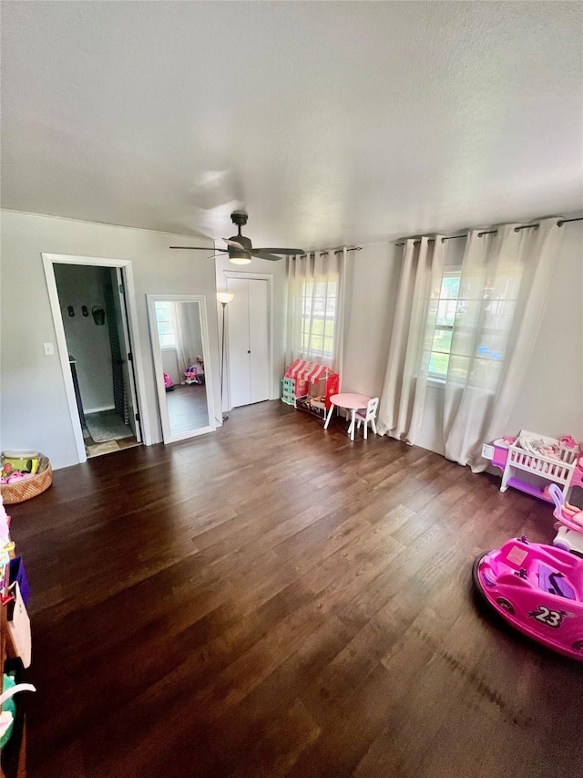 interior space with dark hardwood / wood-style floors and ceiling fan