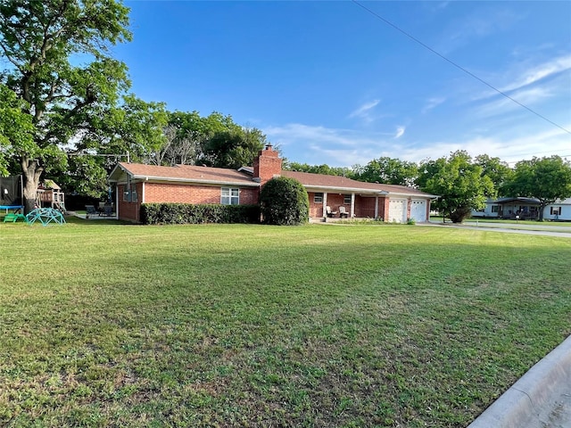 view of front of property with a trampoline and a front lawn