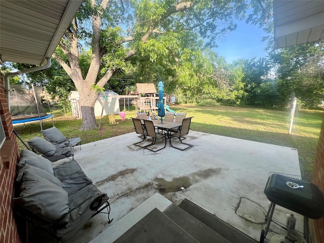 view of patio featuring a playground and a trampoline