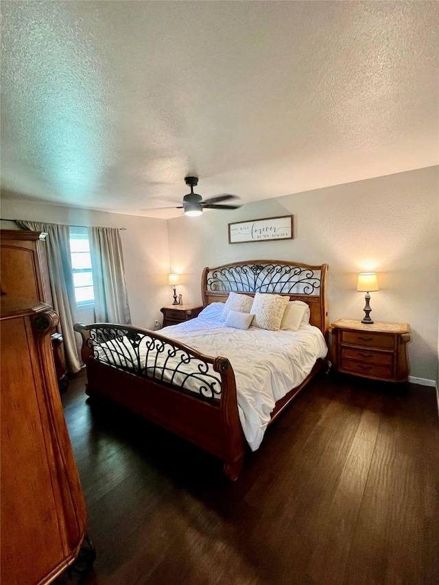 bedroom with a textured ceiling, dark hardwood / wood-style floors, and ceiling fan