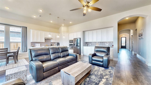 living room featuring ceiling fan and hardwood / wood-style floors