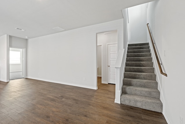 stairs with wood-type flooring