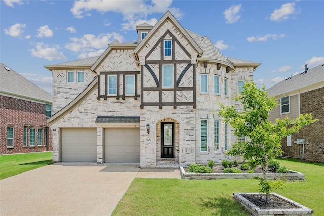 tudor house featuring a front yard and a garage