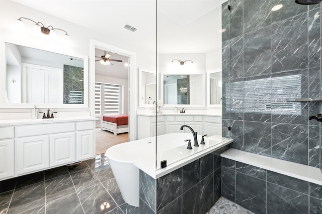 bathroom featuring vanity and independent shower and bath