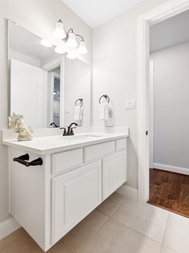 bathroom with tile patterned floors and vanity