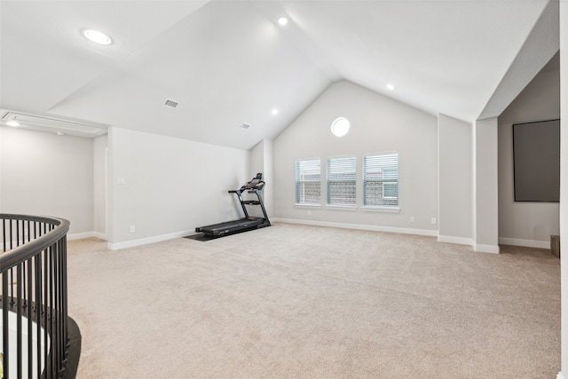 exercise area with light carpet and lofted ceiling