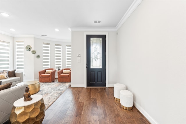 entryway with dark hardwood / wood-style floors and crown molding