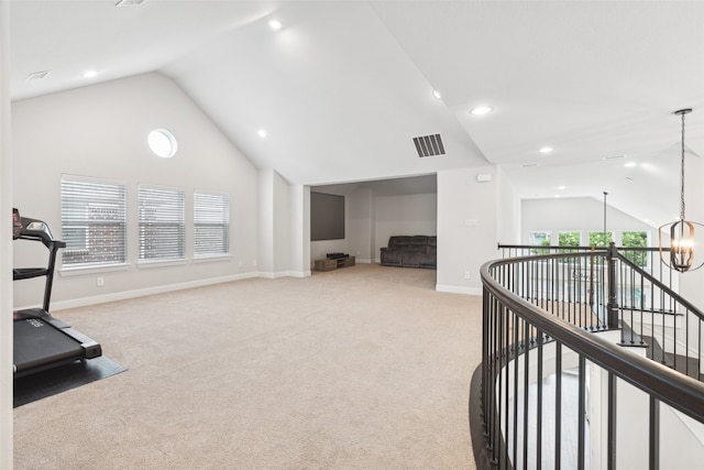 workout area with light colored carpet, lofted ceiling, and an inviting chandelier