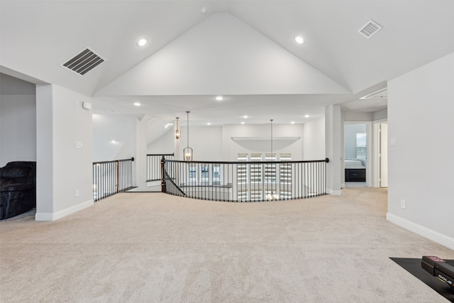 carpeted spare room with lofted ceiling