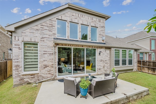 rear view of house featuring an outdoor living space, a yard, and a patio