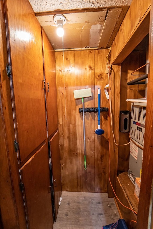 bathroom with hardwood / wood-style floors and wooden walls