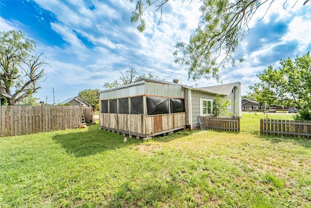 rear view of house featuring a yard