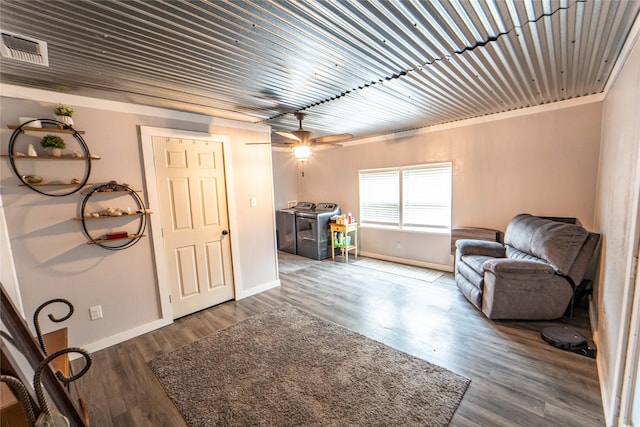 sitting room featuring washing machine and dryer, dark hardwood / wood-style floors, and ceiling fan