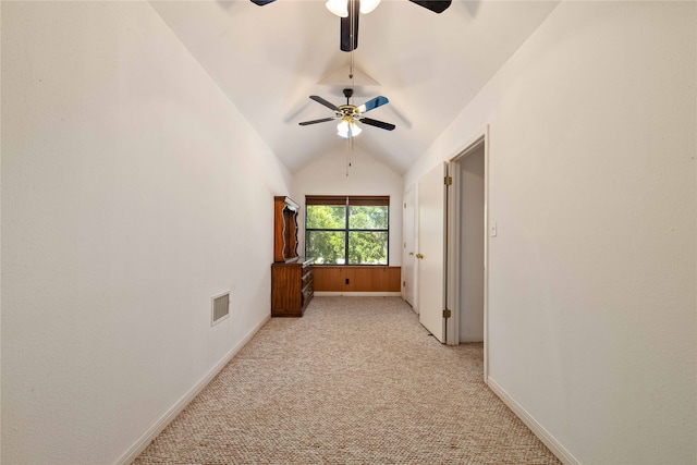 carpeted spare room with ceiling fan and lofted ceiling