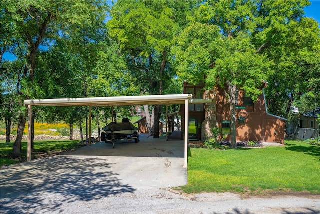 view of vehicle parking with a carport and a yard