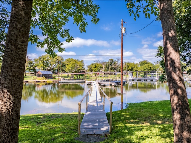 dock area featuring a yard and a water view