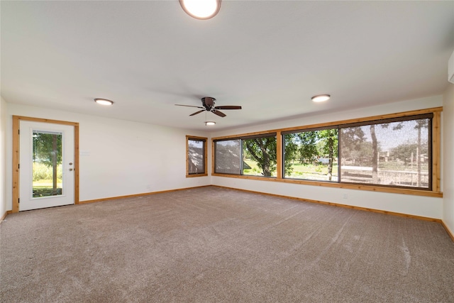 carpeted spare room with ceiling fan