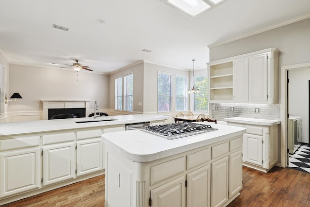 kitchen featuring hardwood / wood-style floors, backsplash, sink, and ceiling fan