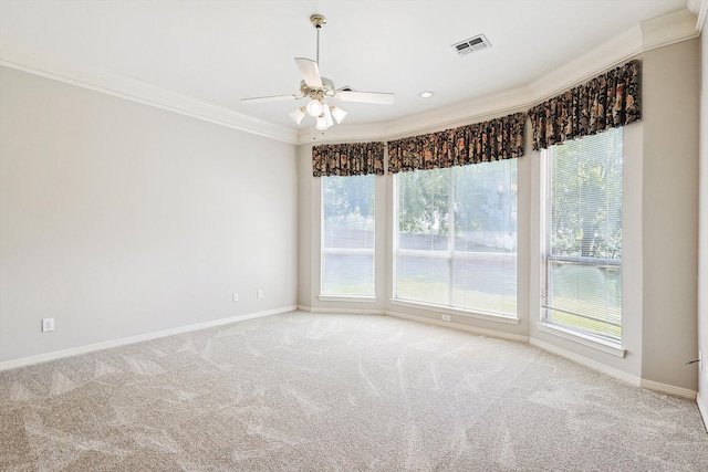 spare room with ceiling fan, plenty of natural light, and ornamental molding