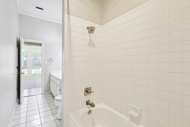 full bathroom with toilet, tiled shower / bath, vanity, and tile patterned floors