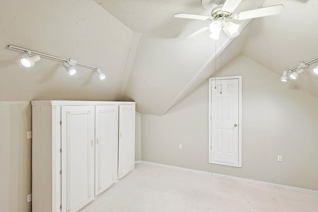 additional living space with ceiling fan, vaulted ceiling, and light carpet