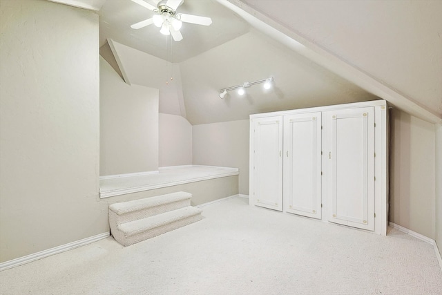 bonus room with ceiling fan, vaulted ceiling, and light carpet