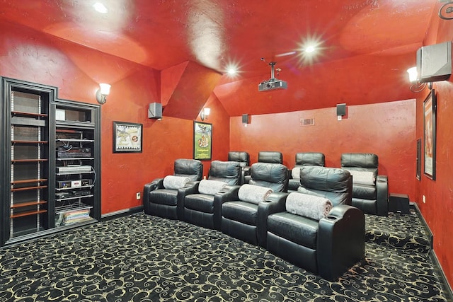 carpeted home theater with lofted ceiling