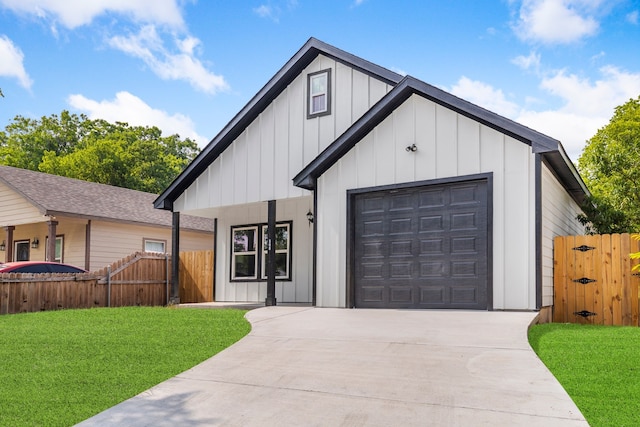 modern farmhouse style home featuring a front lawn and a garage